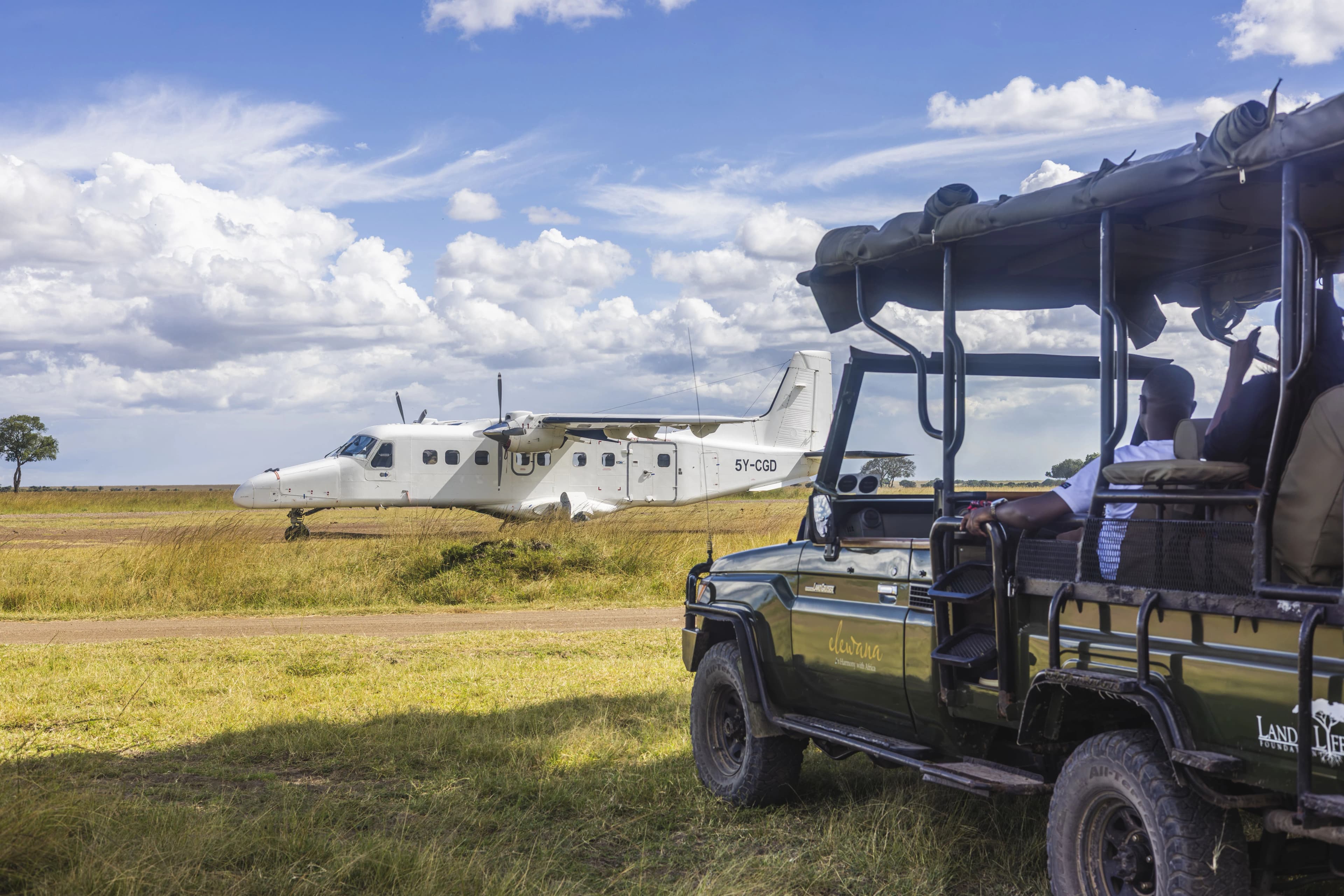 Private charter plane on bush airstrip with savannah in background